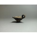 Greek, ceramic oil pourer, 5th century BC. Flat top with short nozzle to front, looped handle to