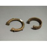 A pair of copper bracelets, West African; 19th - 20th century AD; open torc style with wire
