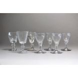 A group of small English drinking glasses, 18th century comprising a deceptive glass, four wines and