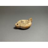 Roman, ceramic oil lamp; 2nd century AD; heart shaped nozzle with round body, dished centre