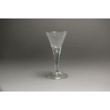 A large English wine glass c.1765 with wide flared trumpet bowl raised above a teardrop knop on a