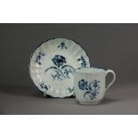 A Caughley porcelain coffee cup and Worcester saucer, circa 1775, of reeded form and painted in the