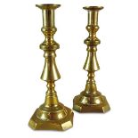 A pair of Victorian brass ejector candle sticks on canted square bases, 27.5cm high