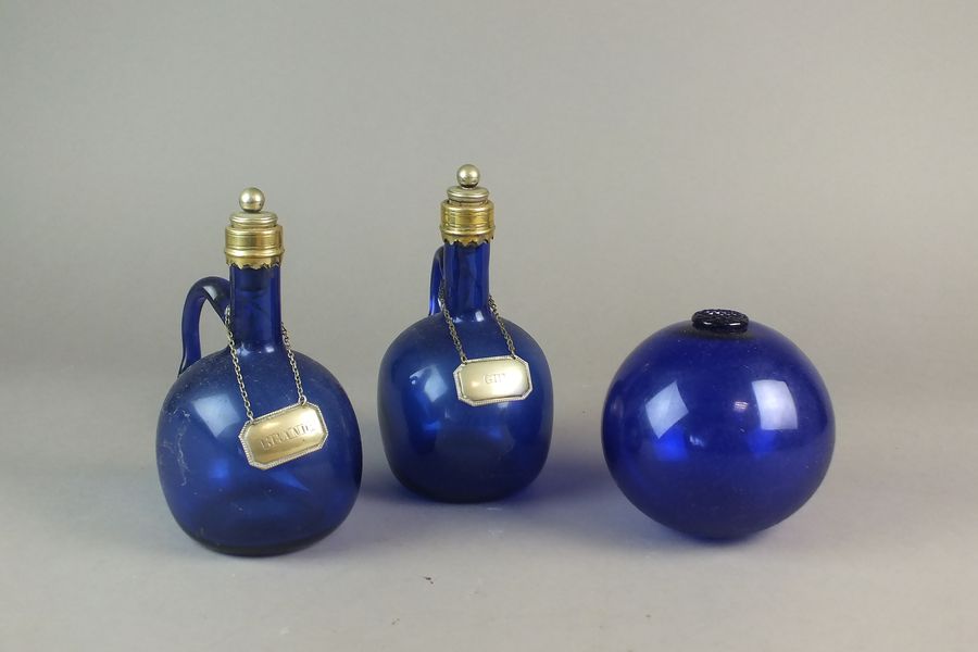 A pair of Bristol blue single-handled decanters and stoppers