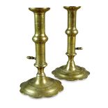 A pair of George III petal leaf base brass candle sticks, 18th century, with ejector action. 17.