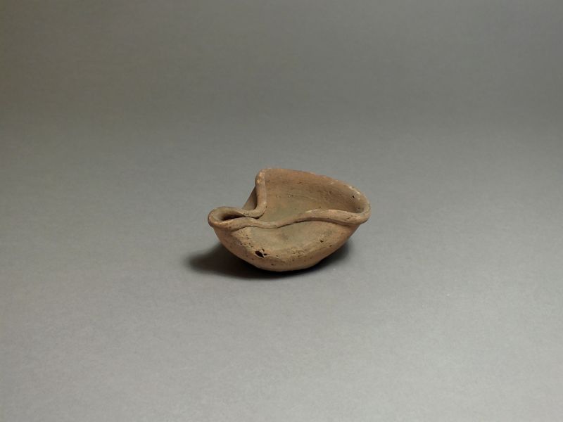 East Greek, ceramic oil lamp, 8th - 7th century BC. Oval body with pinched side to form nozzle