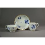 A Worcester porcelain trio of coffee cup, teacup and saucer, circa 1780-85, painted in dry blue with