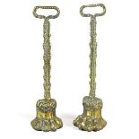 A pair of lead weighted brass door porters, 19th century, each terminating in a lion's paw foot.