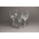 Three oversized George III glasses comprising two goblets and one wine set upon a folded foot, the