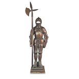 A bronze patinated cast iron fire side figure, 1920s, cast as a standing knight in armour with