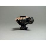 Greek, ceramic black glazed oil pourer, 5th century BC; flat top decorated with repeating wave