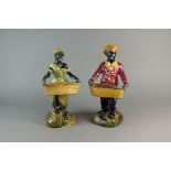 A pair of Victorian majolica Blackamoor figures, modelled as male and female harvesters holding
