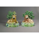 A pair of Walton Staffordshire pearlware lions, circa 1820-30, each modelled seated on a grassy