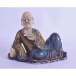 A CHINESE POLYCHROMED CARVED SOAPSTONE FIGURE OF A SCHOLAR modelled holding an open scroll,