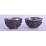 A PAIR OF EARLY 18TH CENTURY CHINESE CARVED COCONUT CUPS Yongzheng, with silver mounts, decorated