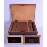 A GROUP OF TWENTY SEVEN VICTORIAN MAGIC LANTERN SLIDES contained within a wooden box, mainly