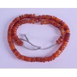 AN EARLY 20TH CENTURY CHINESE CARVED RED AGATE NECKLACE. 52 cm long.