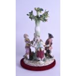 A 19TH CENTURY MEISSEN PORCELAIN FIGURAL GROUP depicting four figures dancing around a tree,