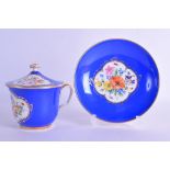 A 19TH CENTURY MEISSEN PORCELAIN CUP COVER AND STAND painted with floral sprays upon a blue