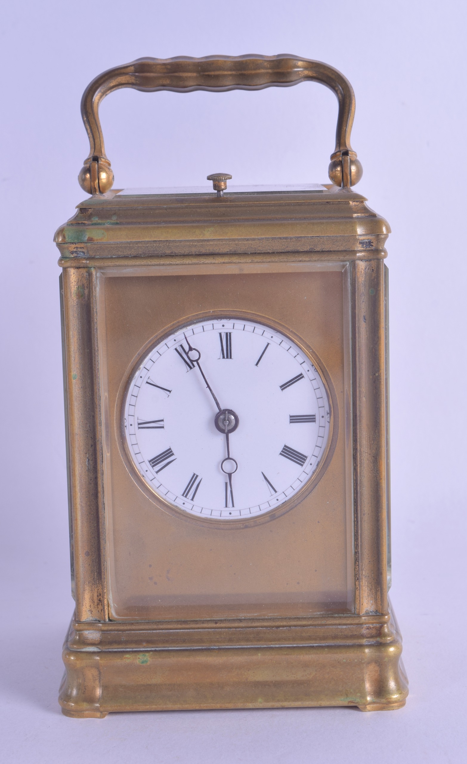 A LATE 19TH CENTURY FRENCH REPEATING BRASS CARRIAGE CLOCK with circular enamel dial and black