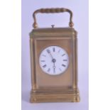 A LATE 19TH CENTURY FRENCH REPEATING BRASS CARRIAGE CLOCK with circular enamel dial and black