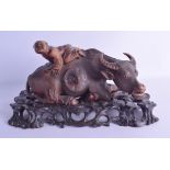 AN UNUSUALLY FINE 19TH CENTURY CHINESE CARVED HARDWOOD BUFFALO modelled with a boy upon his back. 30