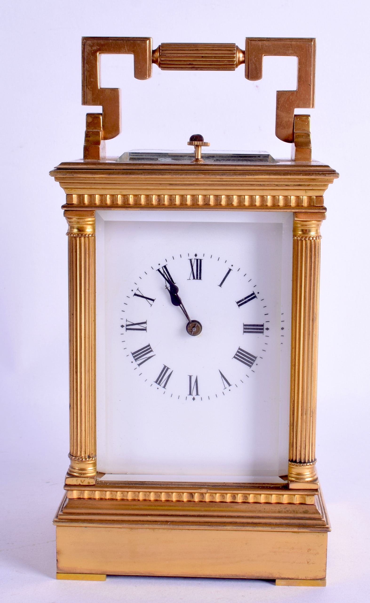 A 19TH CENTURY FRENCH REPEATING MUSICAL CARRIAGE CLOCK with white enamel dial and column supports.