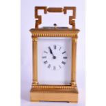 A 19TH CENTURY FRENCH REPEATING MUSICAL CARRIAGE CLOCK with white enamel dial and column supports.