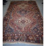 A GOOD PERSIAN RED GROUND RUG, decorated with motifs and symbols. 287 cm x 176 cm.