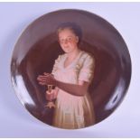 A LATE 19TH CENTURY VIENNA PORCELAIN PLATE painted with a young female holding a candle within an