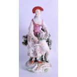 18th c. Derby figure of a woman with a sheep on a rococo base. 20 cm high.