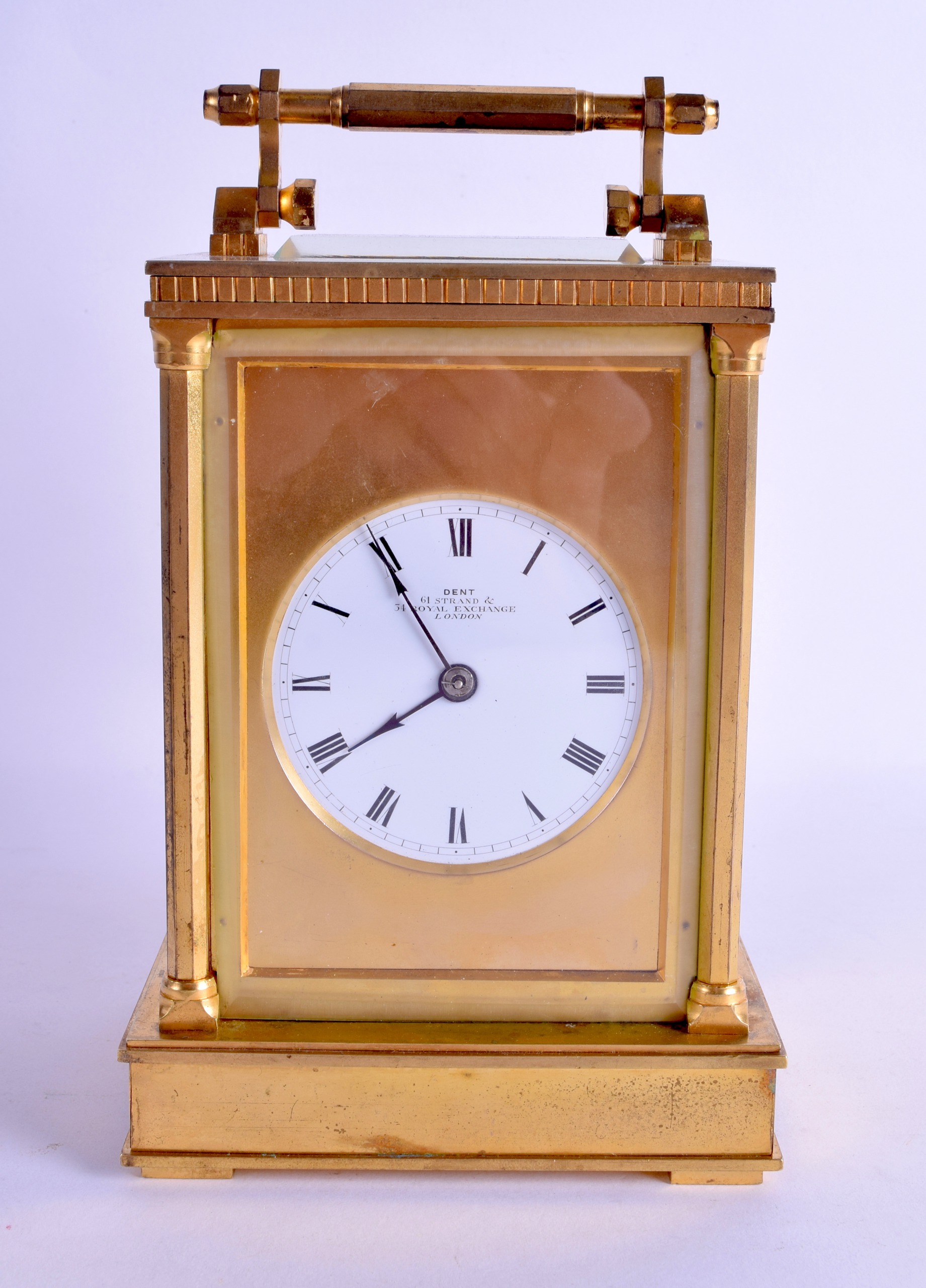 A GOOD LARGE ANTIQUE BRASS CARRIAGE CLOCK by Dent of London, with circular enamel dial and black