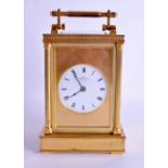 A GOOD LARGE ANTIQUE BRASS CARRIAGE CLOCK by Dent of London, with circular enamel dial and black