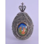 AN UNUSUAL EARLY 20TH CENTURY RUSSIAN SILVER FILIGREE EASTER EGG the doors opening to reveal an