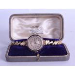 A 9CT GOLD AND ENAMEL WRISTWATCH with yellow metal strap. Overall 22 grams. 2.5 cm diameter.