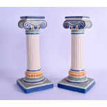 AN UNUSUAL PAIR OF EARLY 20TH CENTURY FRENCH POTTERY CANDLESTICKS in the form of Corinthian columns.