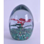 A CONTINENTAL FACETTED GLASS PAPERWEIGHT decorated with an upright single red flower. 12 cm high.