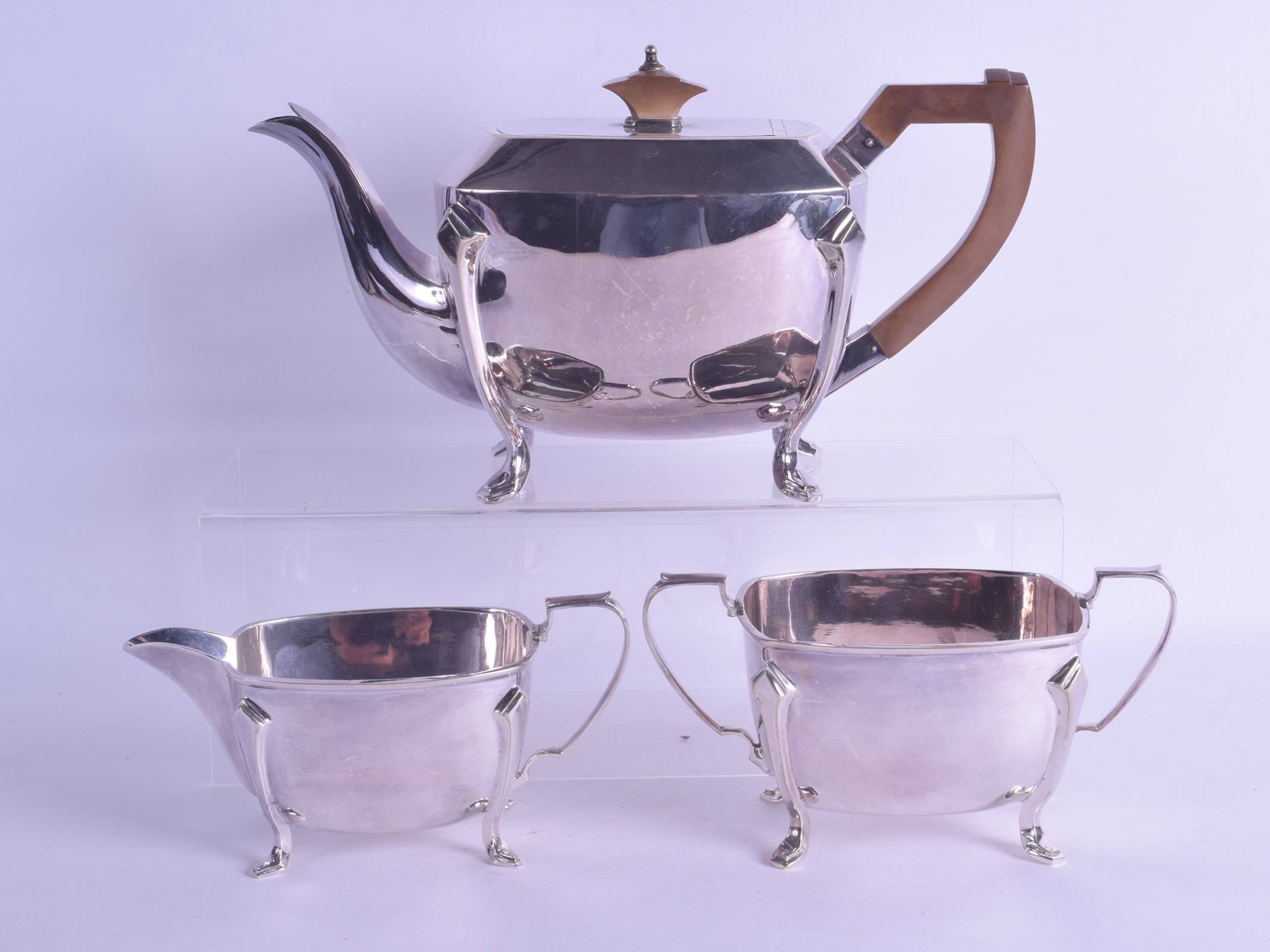 AN ART DECO SILVER PLATED THREE PIECE TEA SET. Largest 26.5 cm wide. (3)