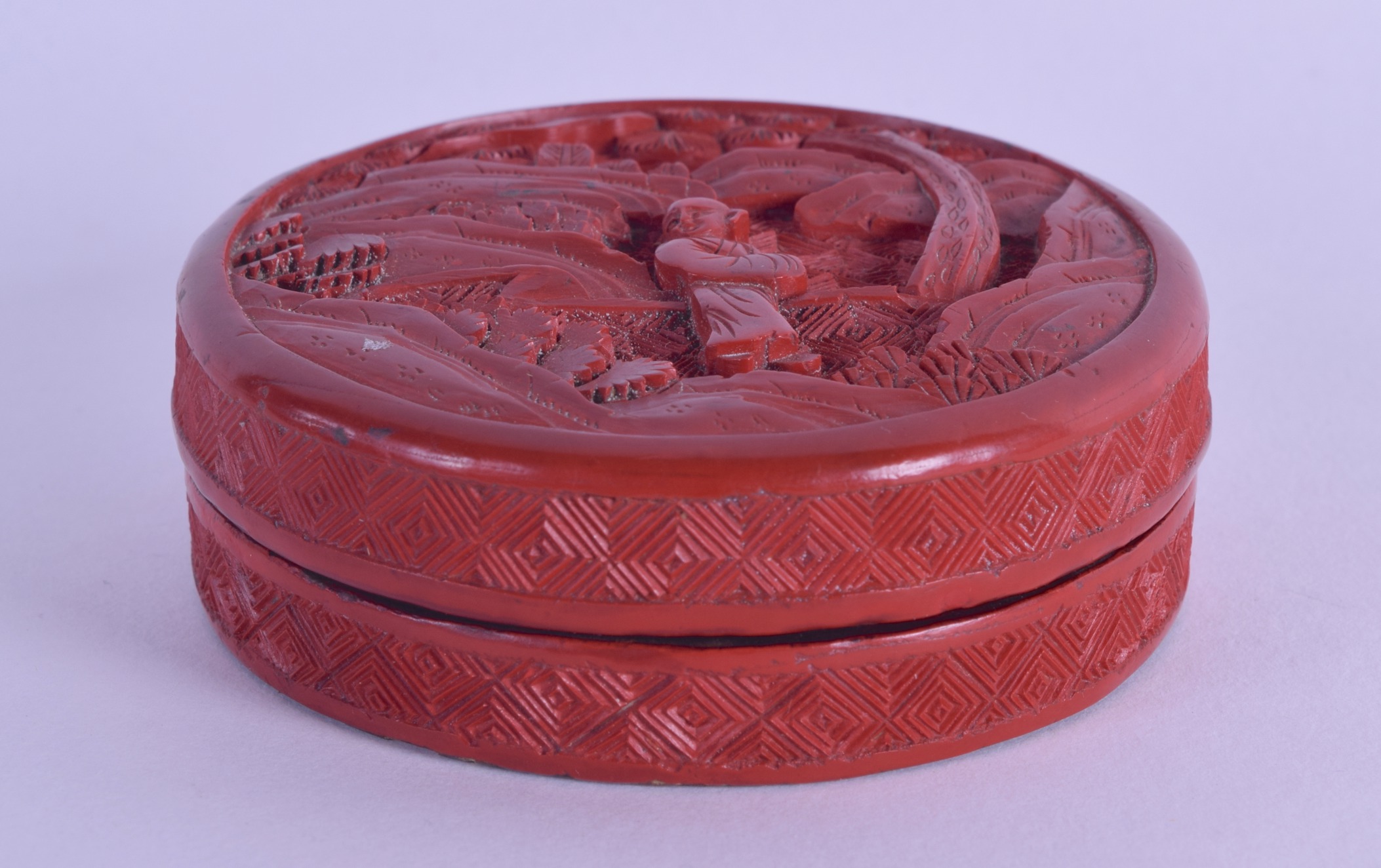 AN 18TH/19TH CENTURY CHINESE CARVED CINNABAR LACQUER BOX AND COVER carved with a single figure