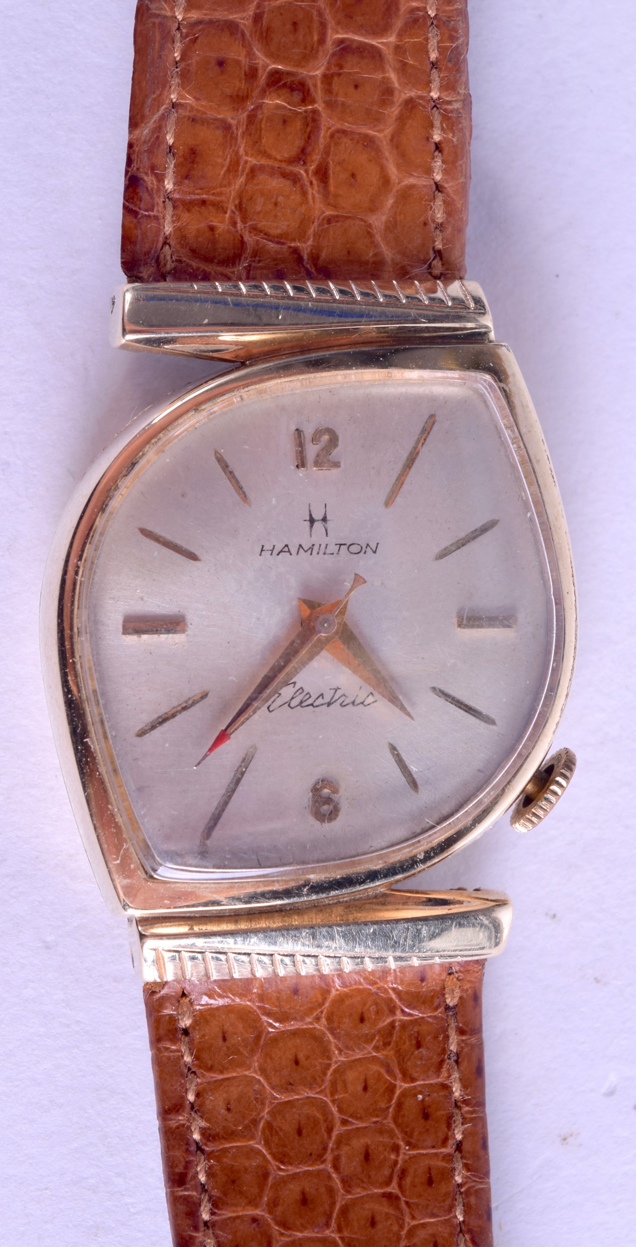 A STYLISH 10K GOLD FILLED HAMILTON ELECTRIC WRISTWATCH with unusual shaped dial. 2.75 cm wide.