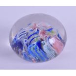 AN ANTIQUE GLASS PAPERWEIGHT decorated with multi coloured canes. 7 cm diameter.