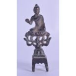 A CHINESE QING DYNASTY BRONZE FIGURE OF A BUDDHISTIC GOD modelled upon an open work column. 10.25 cm