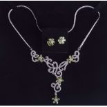 A SILVER PERIDOT AND ZIRCON SET NECKLACE with matching earrings. (3)