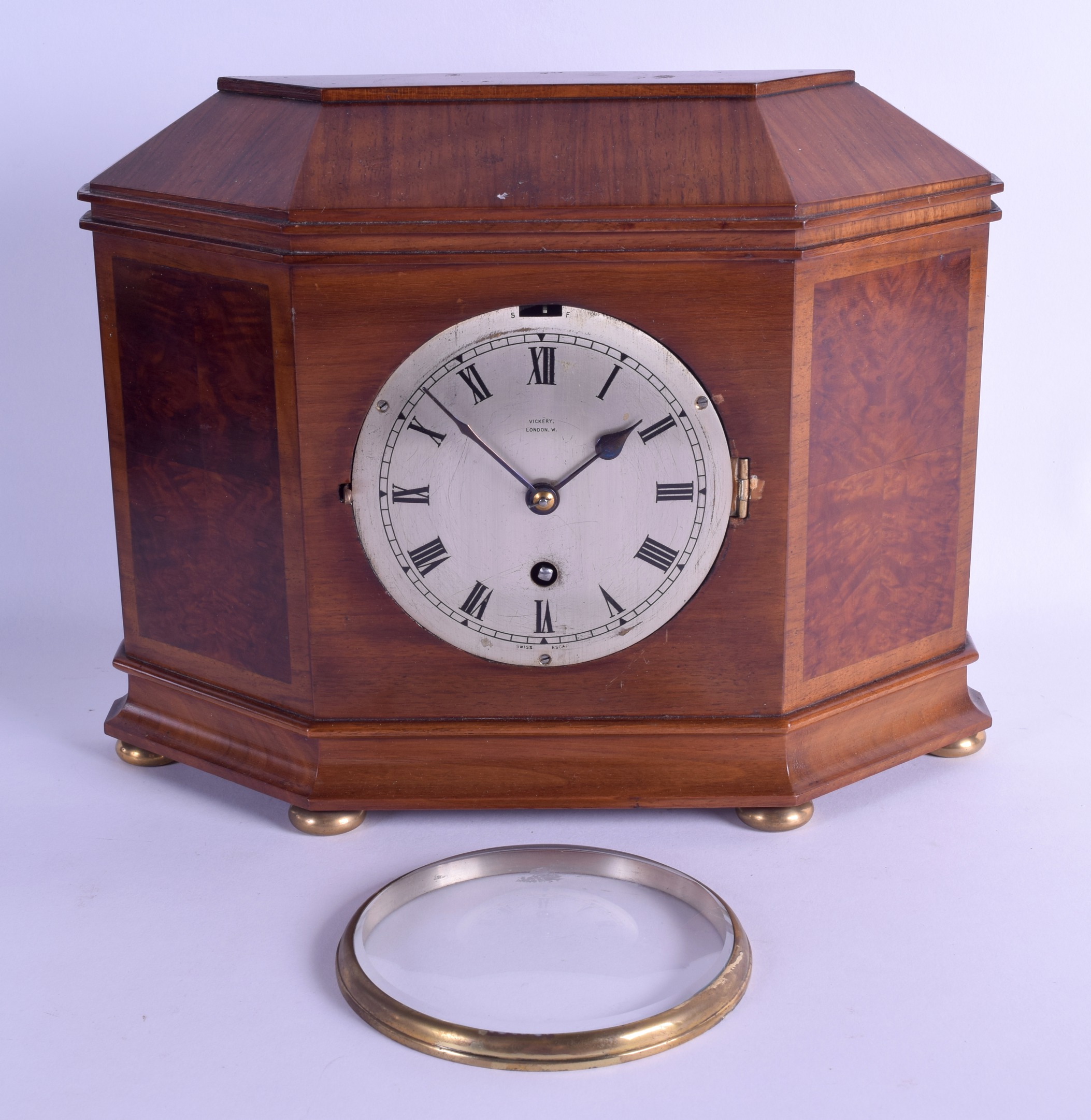 AN ANTIQUE VICKERY OF LONDON MAHOGANY AND WALNUT MANTEL CLOCK with silvered dial and black numerals.