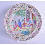 A 19TH CENTURY CHINESE CANTON FAMILLE ROSE PLATE painted with five figures within a garden. 25 cm