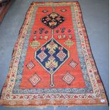 AN ANTIQUE KURDISH TRIBAL RUG, decorated with symbols. 226 cm x 108 cm.