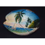 A LARGE NUT, painted with boats sailing in coastal scenes. 28 cm wide.