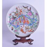 A 19TH CENTURY CHINESE CANTON FAMILLE ROSE PLATE painted with three figures within an interior. 20