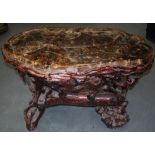 A LARGE HARDWOOD TABLE OF NATURALISTIC FORM, inset with a slab of hardstone. 82 cm x 100 cm.