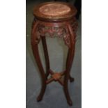 A TALL CHINESE CARVED HARDWOOD STAND, inset with marble panel and foliate frieze. 91 cm x 45 cm.